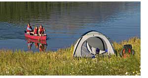 Camping Site And Boat With Campers