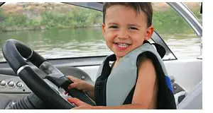 Happy Boy Driving Dad's Boat
